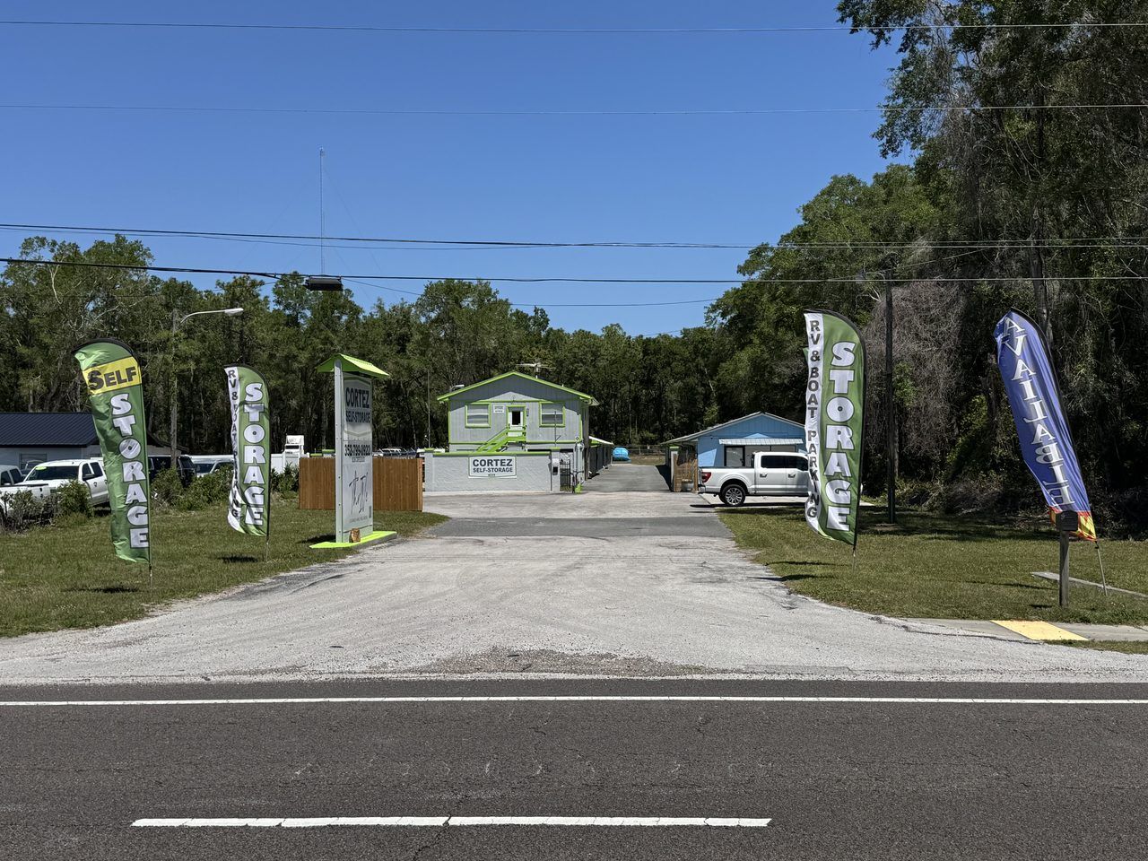 Cortez Self Storage at 16339 Cortez Blvd in Brooksville, FL — pylon sign and lime-green-trimmed office visible from the road.